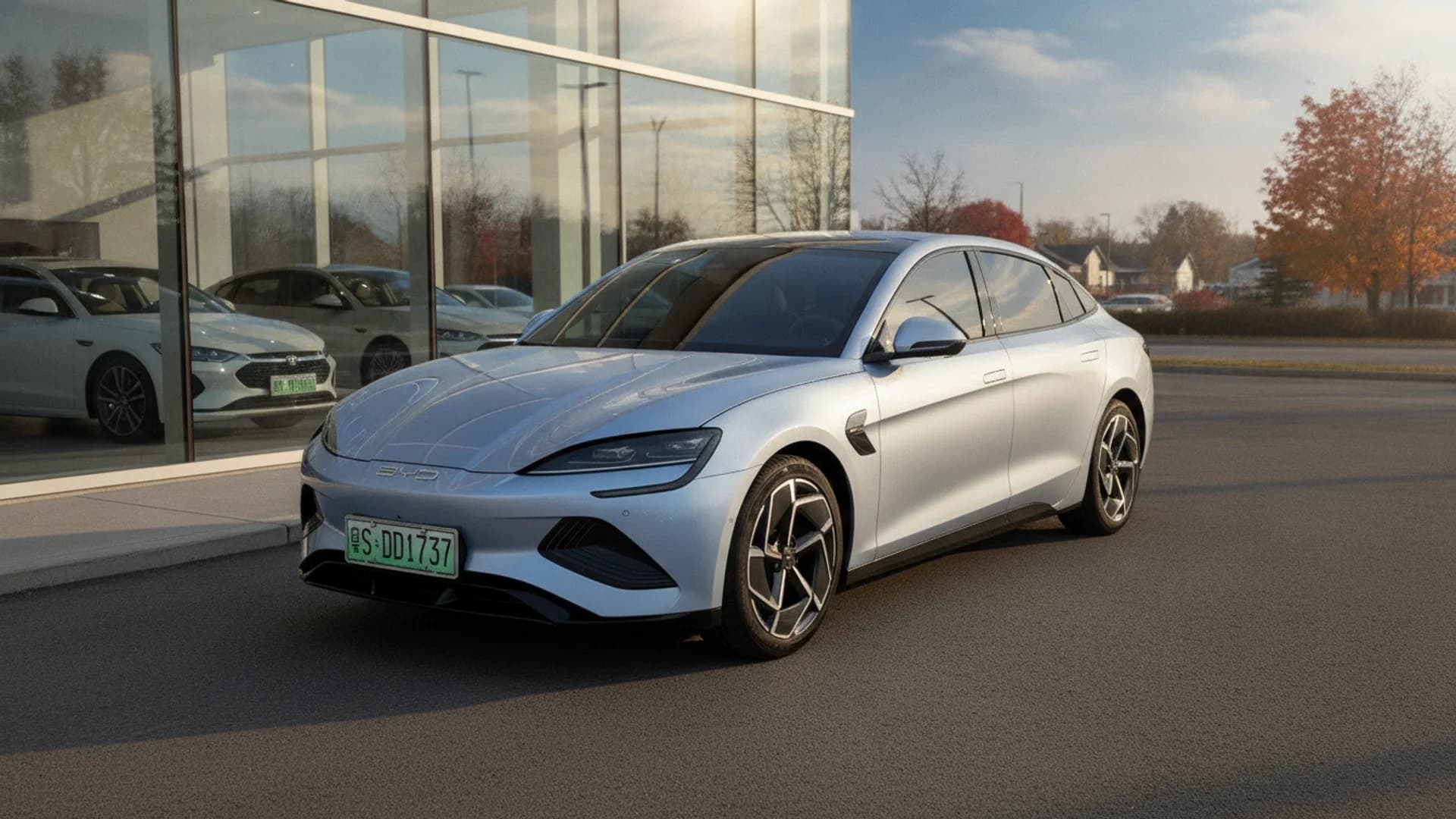 A silver BYD Seal electric sedan parked outdoors in front of a modern dealership building.