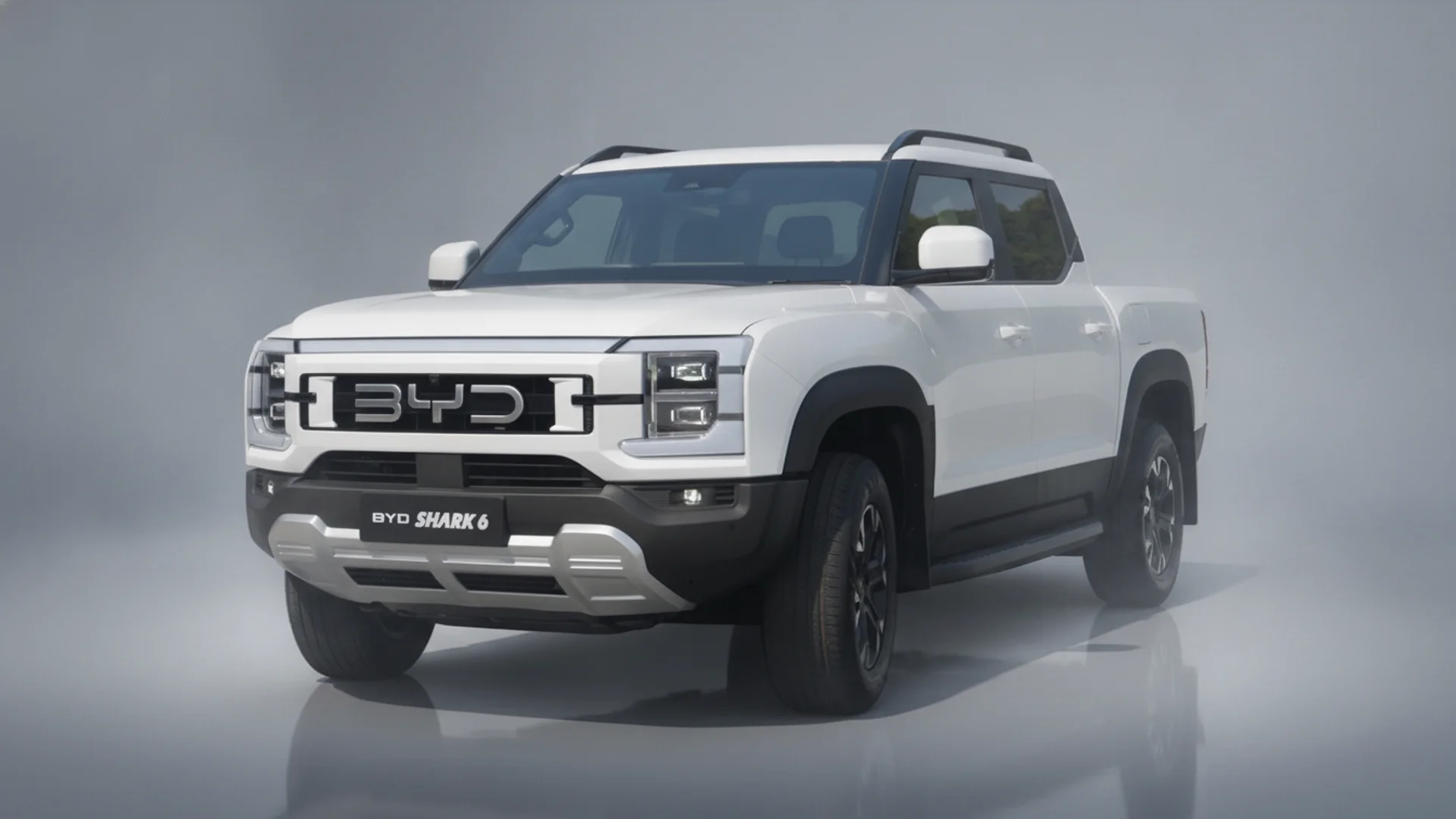 A white BYD Shark 6 pickup truck is angled slightly right, showcasing its front grille and headlights.