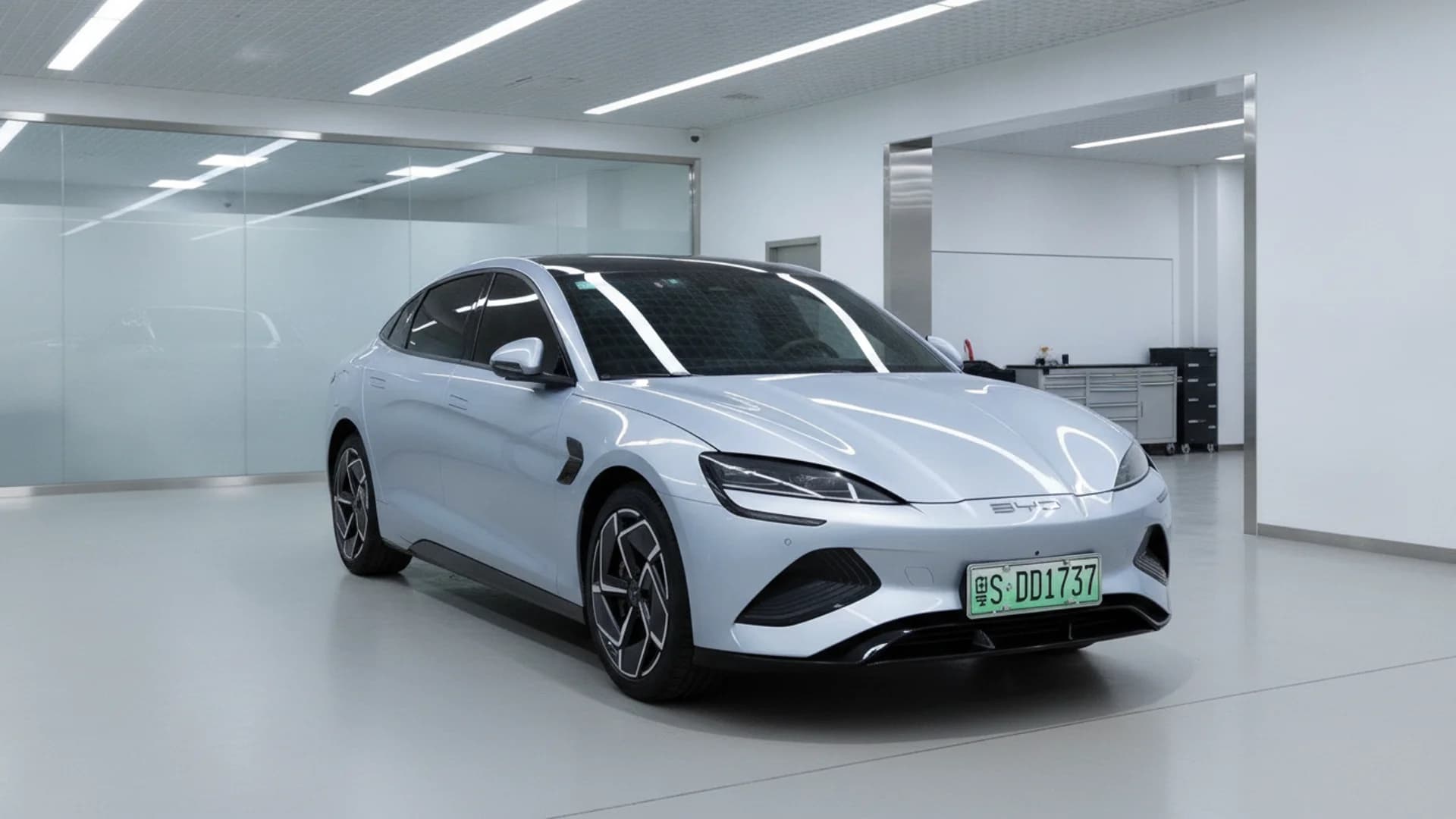 A light blue BYD Seal electric sedan parked inside a bright, modern studio room.