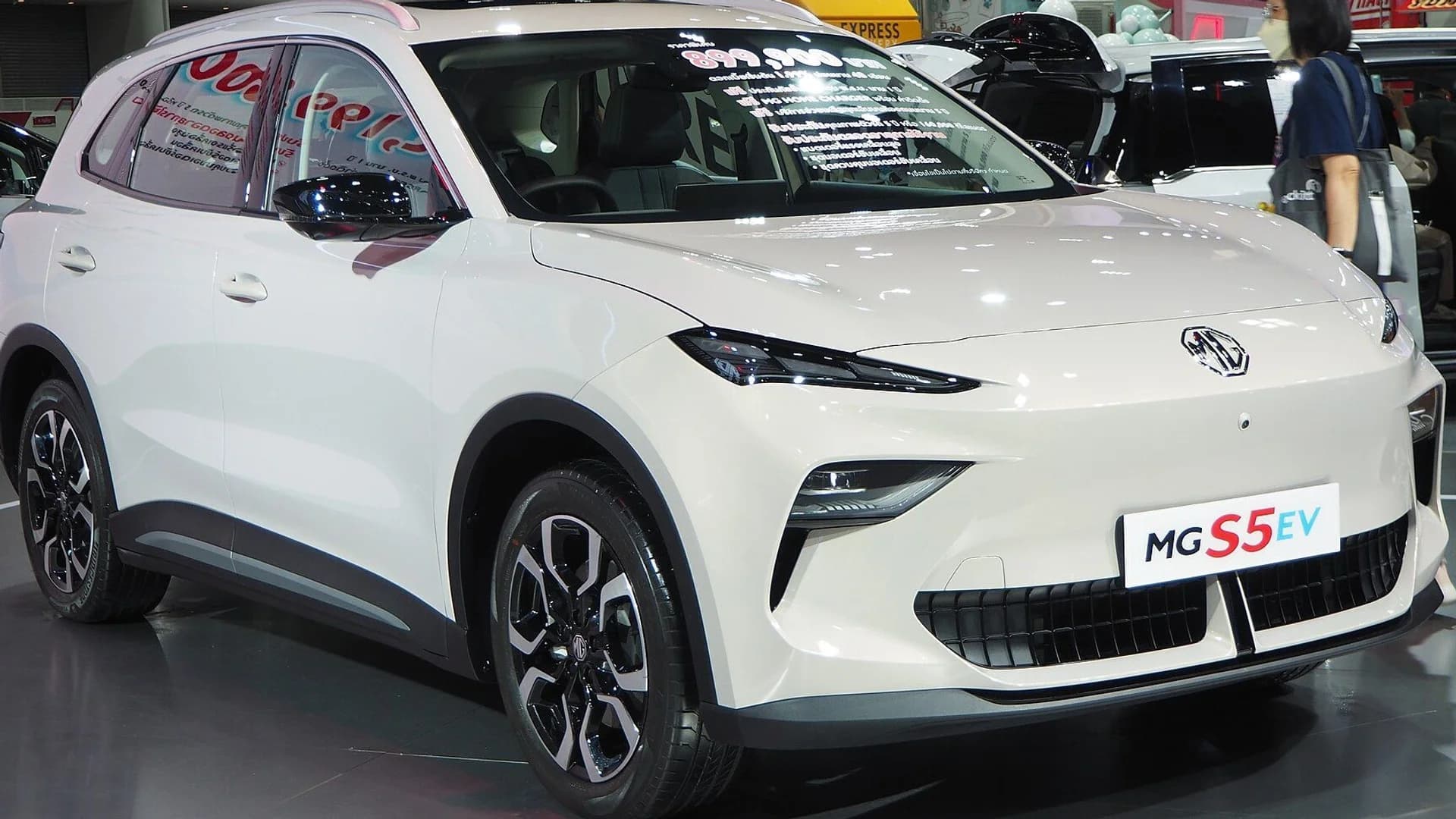 A white MG S5 EV electric crossover on display at an auto show.