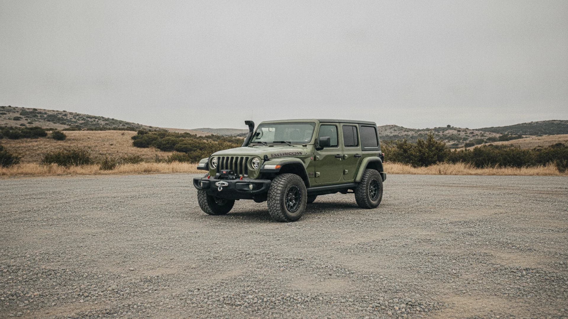 Jeep Wrangler parked outdoors in an open lot away from buildings