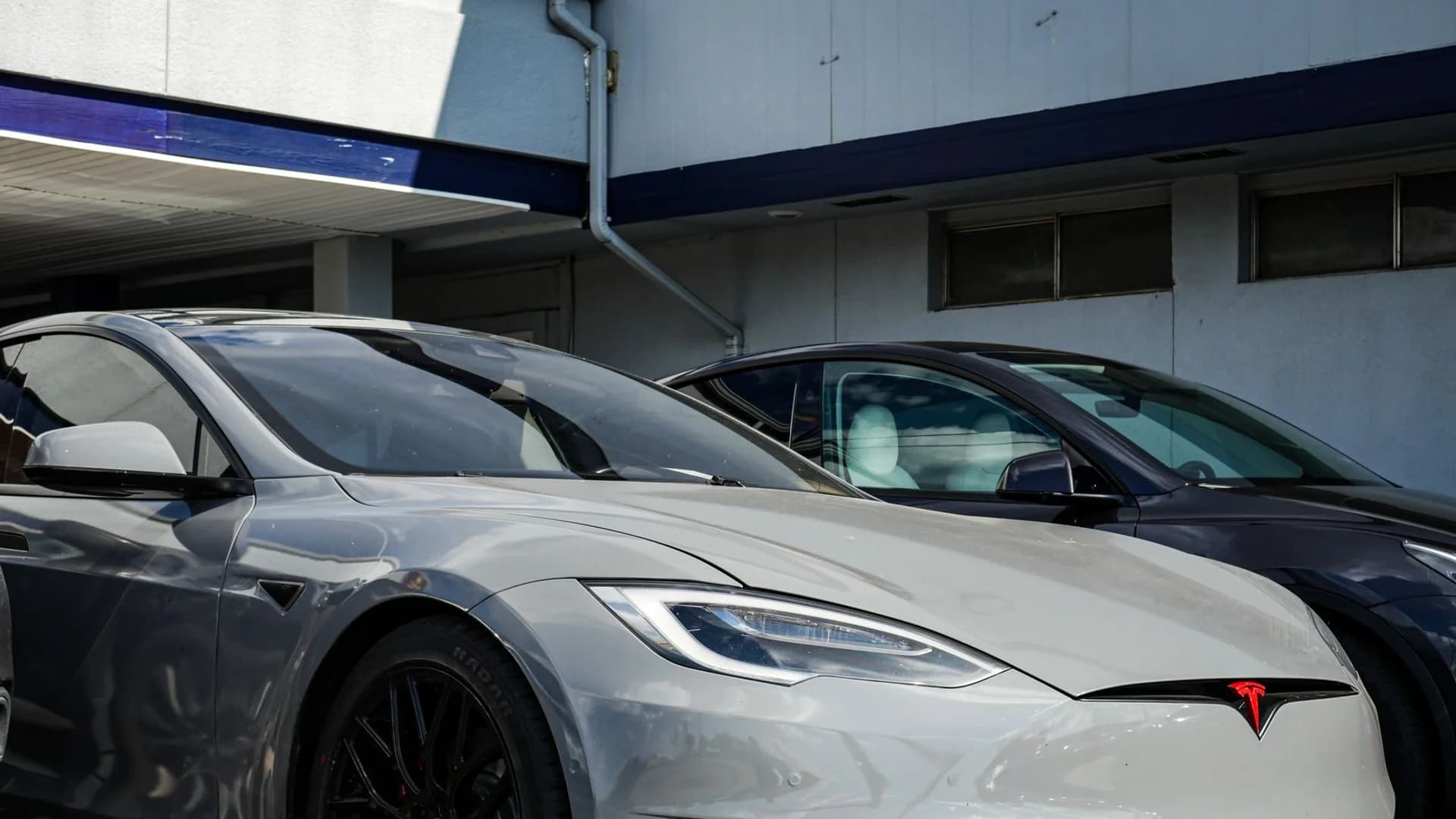 Close-up view of a sleek Tesla Model S parked outdoors, showcasing modern electric vehicle design.