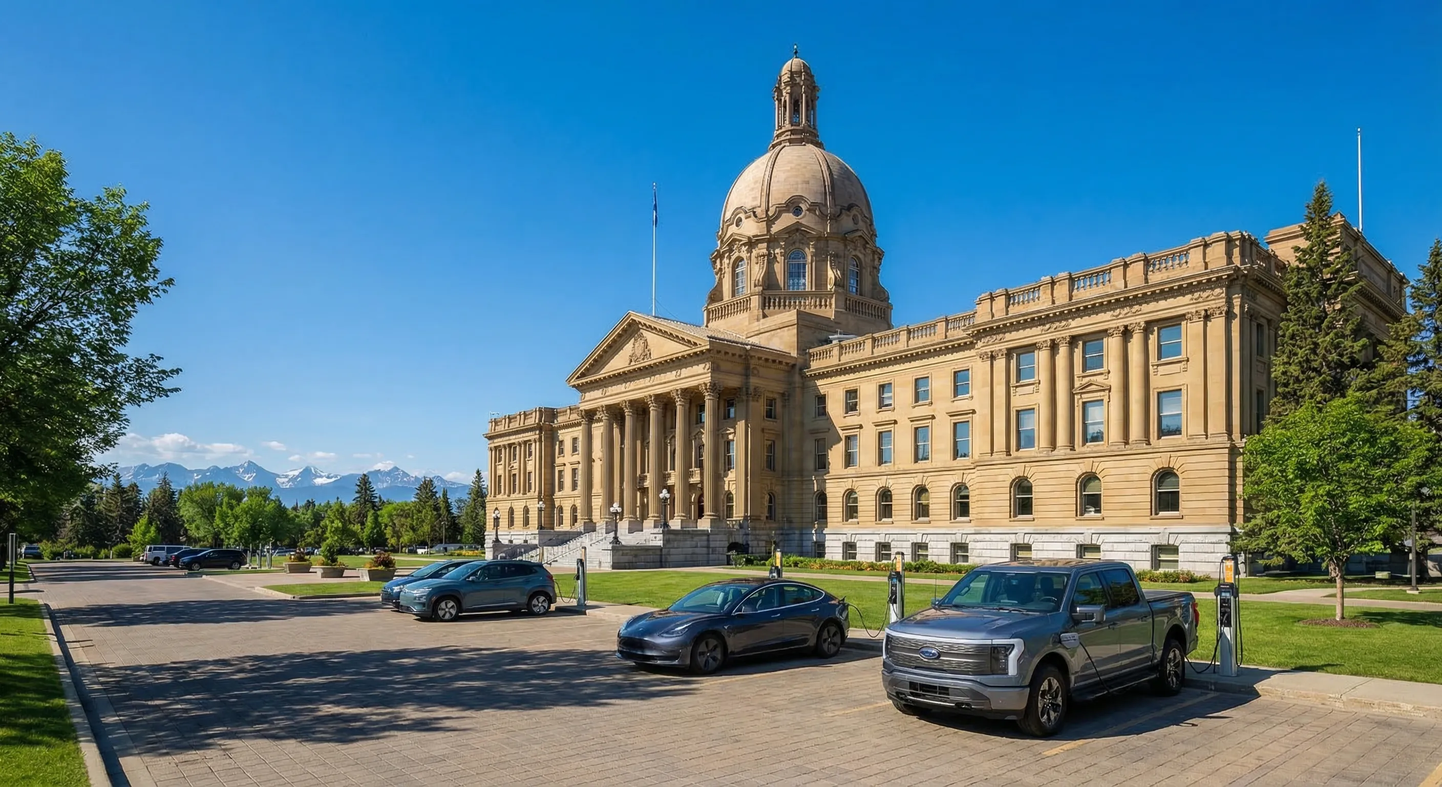 Alberta legislature building in Edmonton with electric vehicles parked in front and Rocky Mountains in background