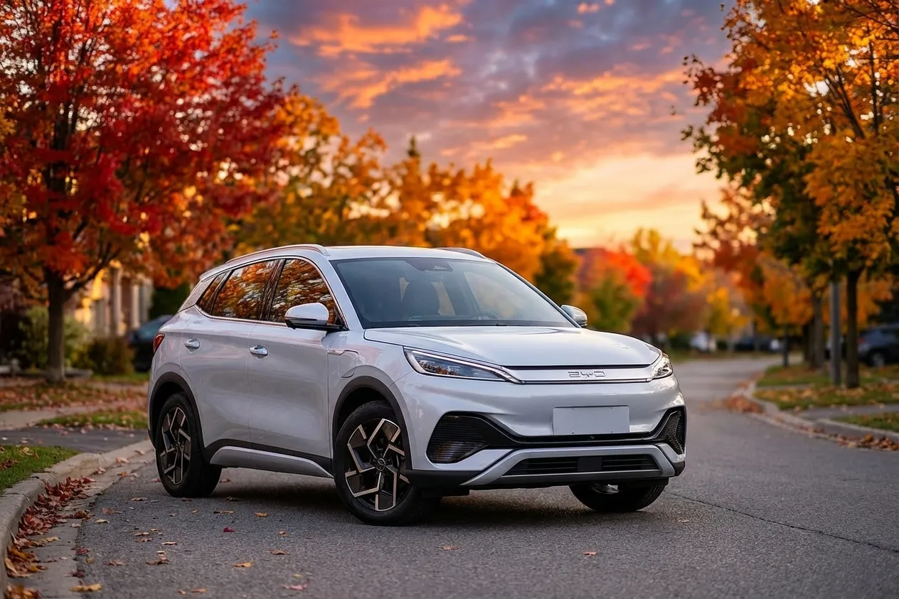 Silver BYD Atto 3 electric SUV on a Canadian suburban street with autumn maple trees