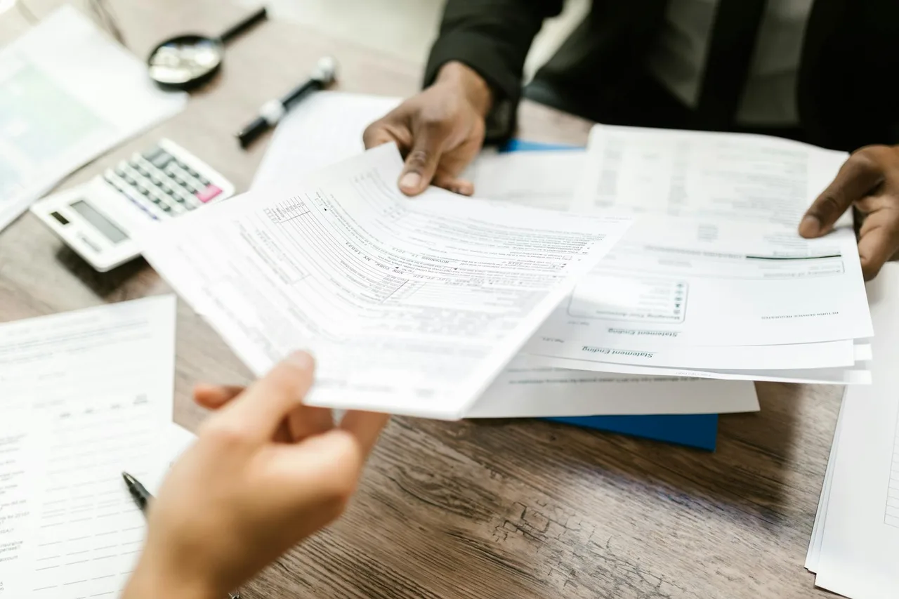 Car insurance paperwork and documents on a desk representing EV insurance cost analysis and premium comparisons