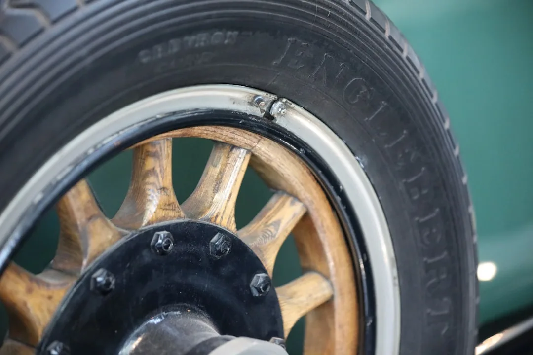 Red electric car parked outdoors, showcasing sleek design amidst winter scenery.