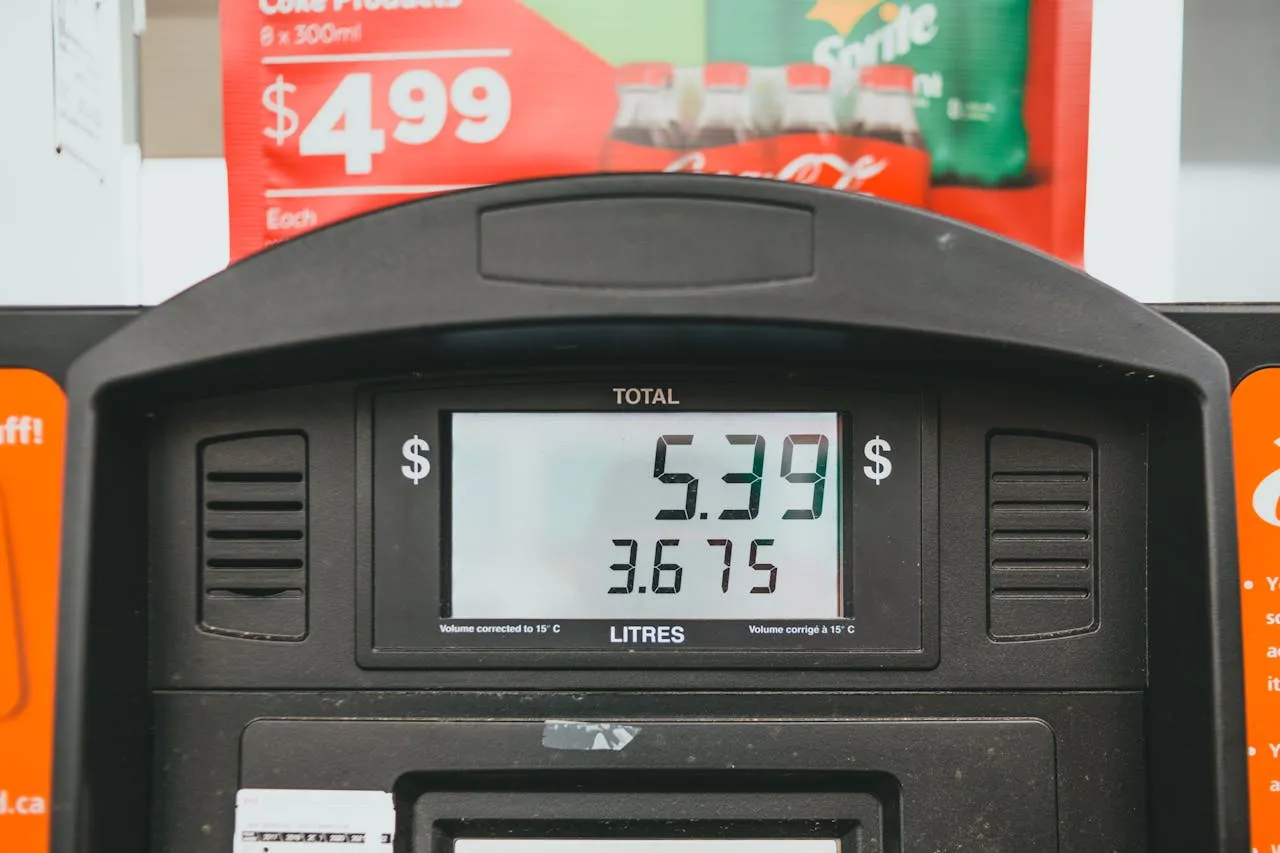 Close-up of a gas pump display showing price per litre during a fill-up in Canada