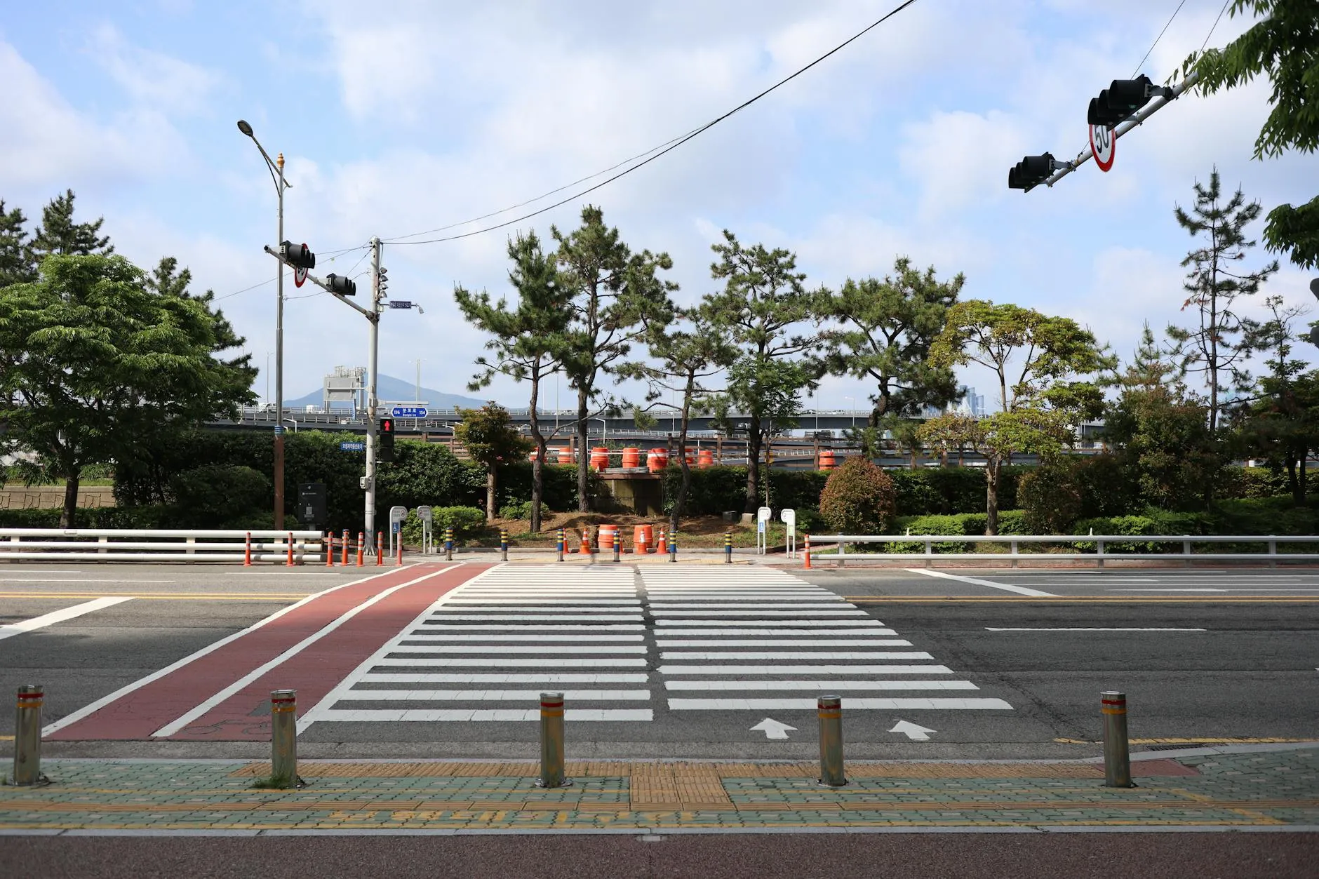 Close-up of a person plugging in an electric car at a charging station outdoors.