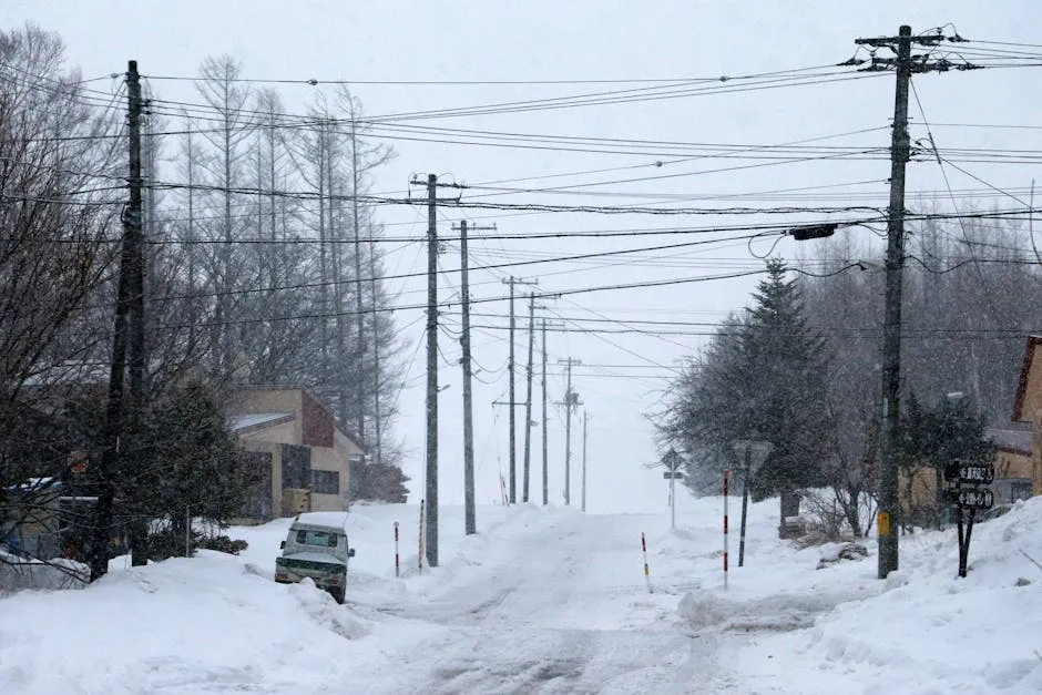 Electric vehicle driving on a snowy Norwegian road during winter range testing