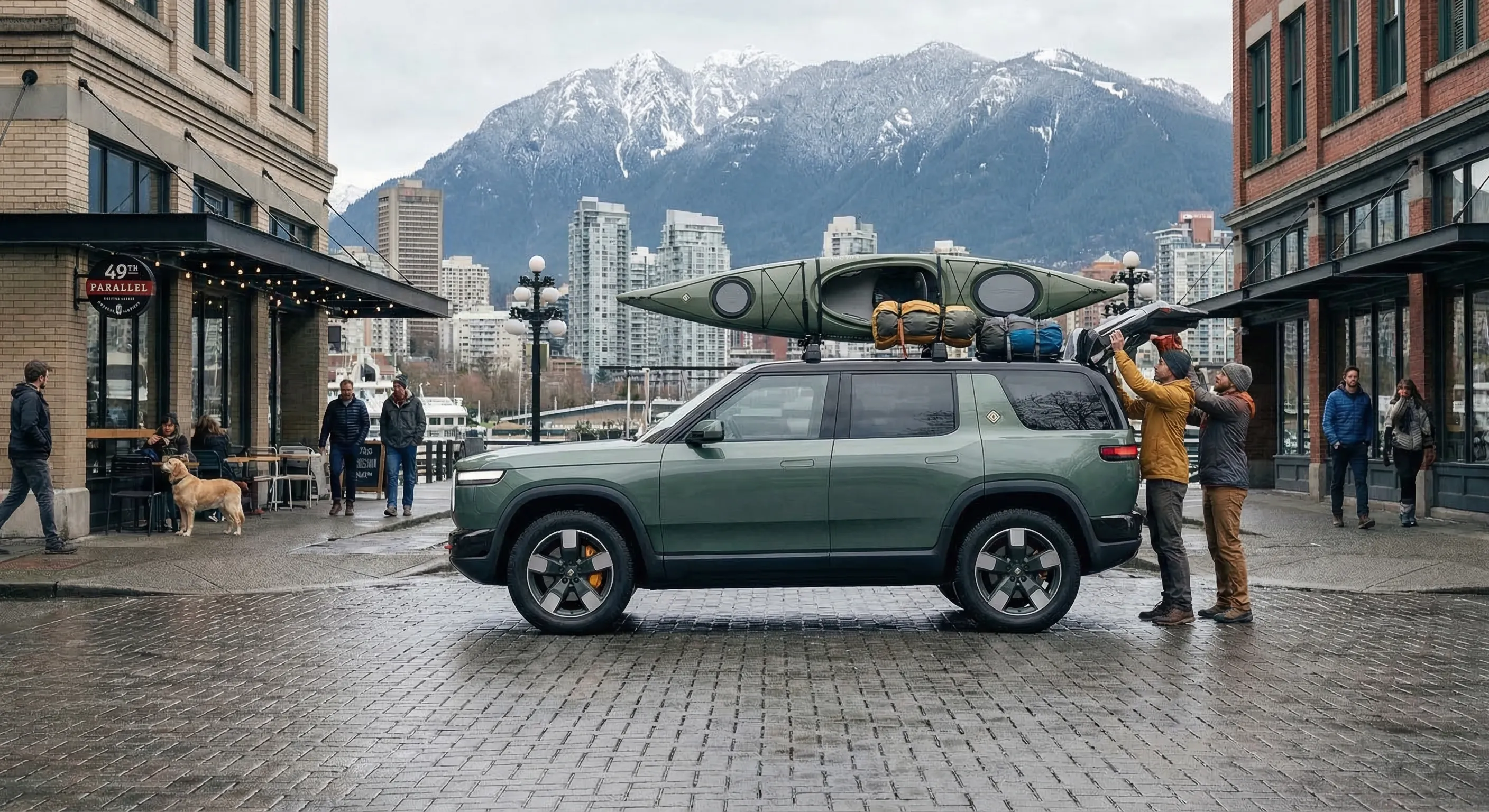 Rivian R2 compact electric SUV parked in Vancouver with mountains in background — urban adventure lifestyle in Canada