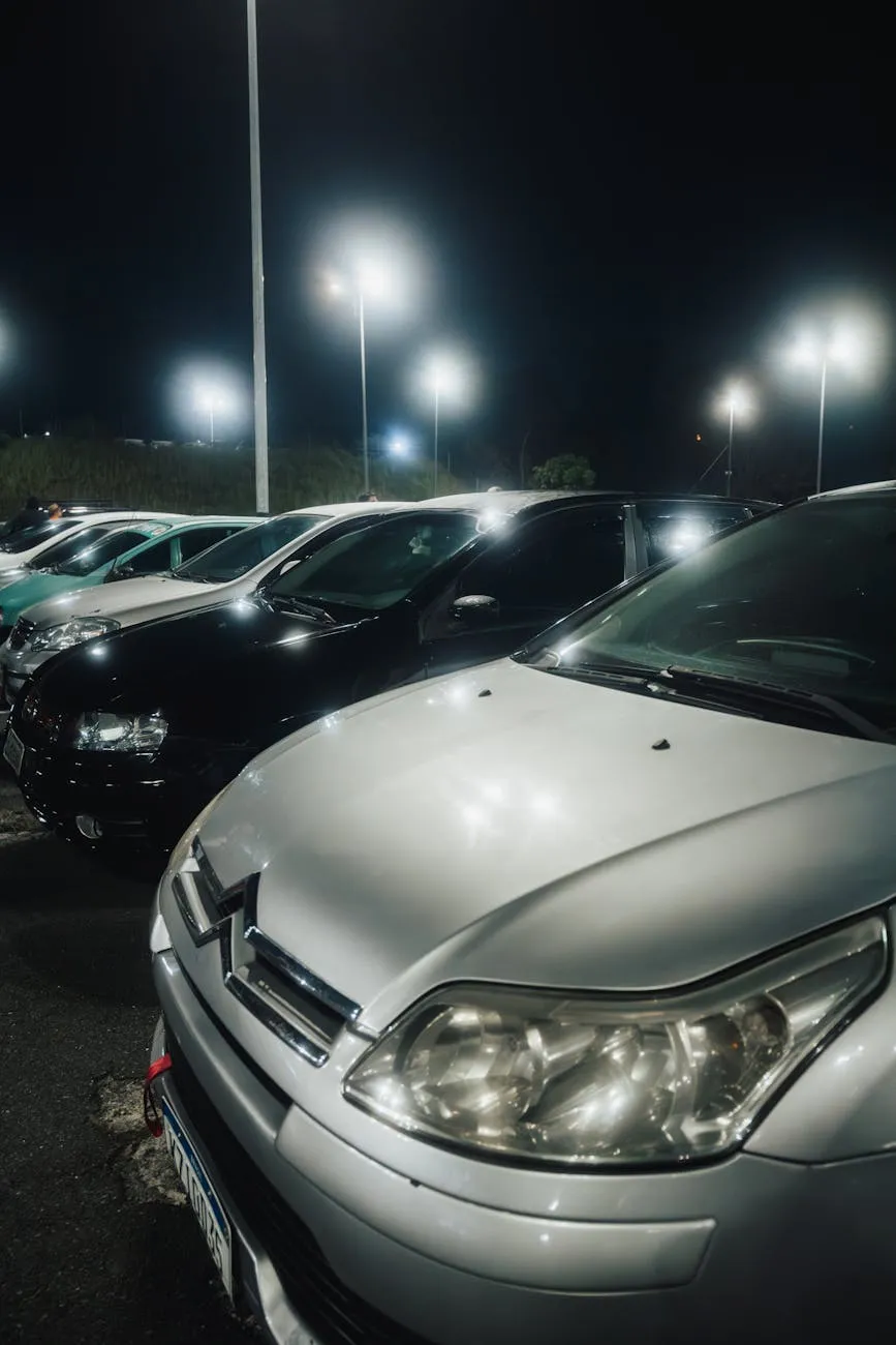 Close-up of a person plugging in an electric car at a charging station outdoors.
