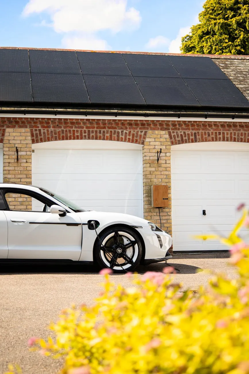 Electric vehicle parked over a wireless inductive charging pad, demonstrating the future of cable-free EV charging